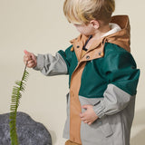 Studio shot of child wearing CRYWOLF Explorer Jacket Moss Forest