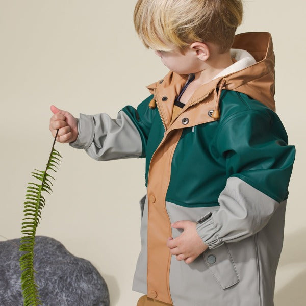 Studio shot of child wearing CRYWOLF Explorer Jacket Moss Forest