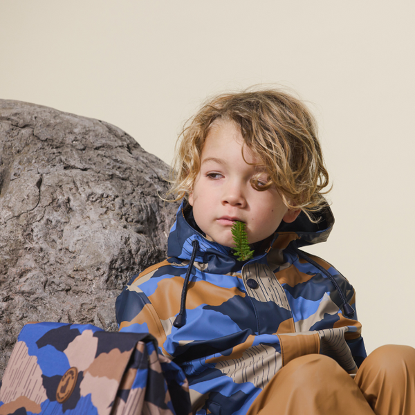 Child sitting wearing CRYWOLF Play Jacket Camo Mountain
