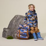 Child leaning against rock wearing CRYWOLF Play Jacket Camo Mountain and Southern Blue rain boots