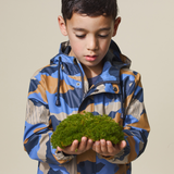 Child holding moss wearing CRYWOLF Play Jacket Camo Mountain