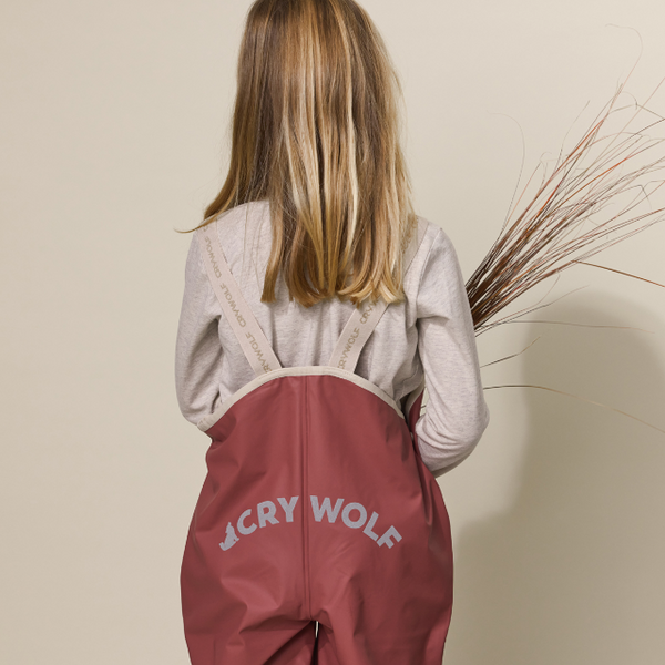 Back view of child wearing CRYWOLF Rain Overalls Rosewood