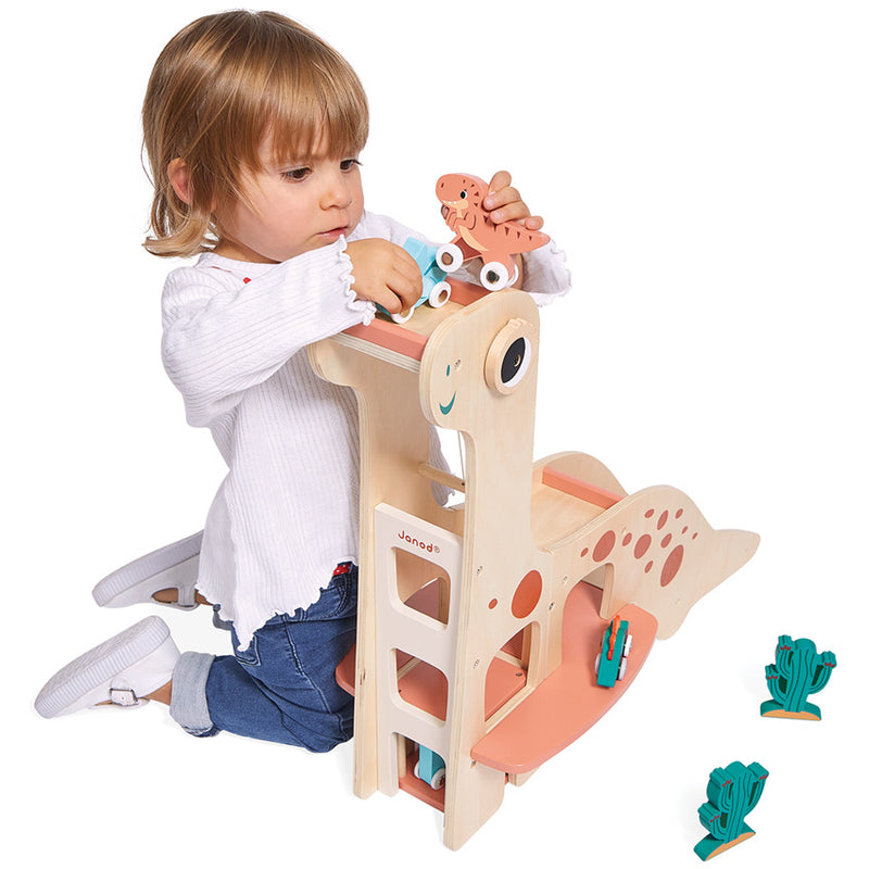 Child playing with the JANOD Dino Garage