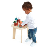 Child playing with the JANOD Dino Activity Table