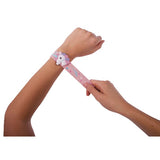 Child putting on the pink IS GIFT Unicorn Fantasy Slap Bands