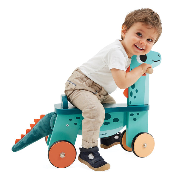 Child riding the JANOD Dino Ride On Portosaurus