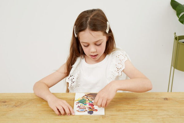 Girl playing with TIGER TRIBE Collage Art Set