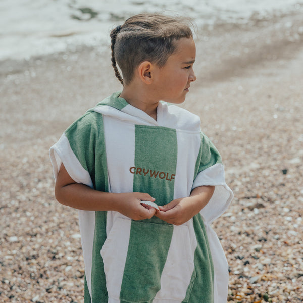 Child at beach wearing CRYWOLF Hooded Towel - Coastal Stripe