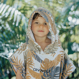 Child wearing the CRYWOLF Hooded Towel - Tan Monstera detail view
