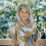 Child wearing the CRYWOLF Hooded Towel - Tan Monstera  detail view
