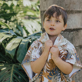 Child wearing the CRYWOLF Hooded Towel - Tan Monstera 