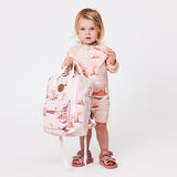 Child holding the CRYWOLF Mini Backpack - Sunset Lost Island