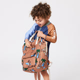 Child holding the CRYWOLF Mini Backpack - Surf'n Mr Wolf