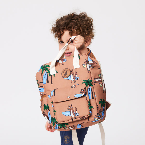 Child holding the CRYWOLF Mini Backpack - Surf'n Mr Wolf detail view