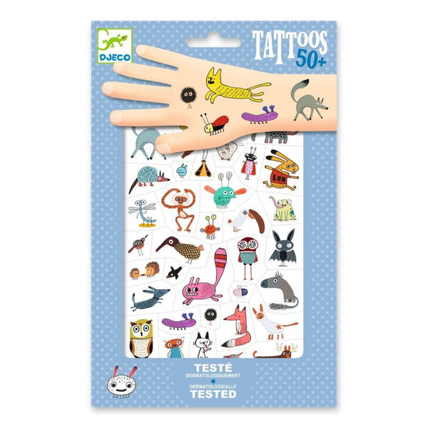 Packaged tattoos with cartoon designs on a blue polka dot background, featuring the brand 'Djeco'.