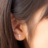 Detail view of girl wearing LAUREN HINKLEY Petite Fleur Diamante Cross earrings '