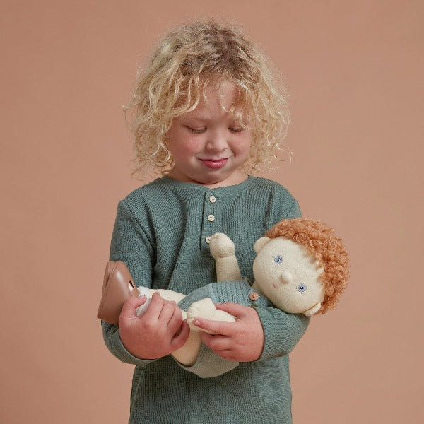 Child holding OLLI ELLA Dinkum Doll - Pea