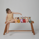 Child sitting on wooden bench with the 6 backyard buddies