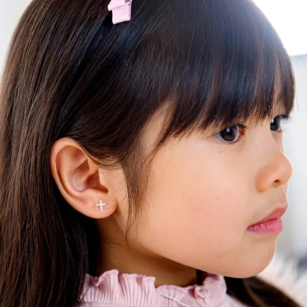 Girl wearing LAUREN HINKLEY Petite Fleur Diamante Cross earrings 