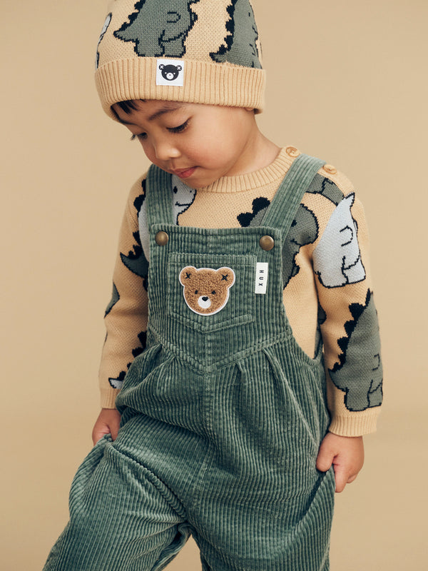 Child wearing the HUXBABY Light Spruce Cord Overalls over the T-Rex knit jumper and beanie