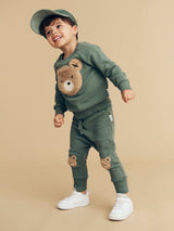Child wearing HUXBABY Light Spruce Furry Huxbear Sweatshirt and drop crotch pant