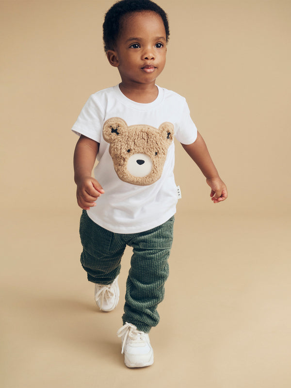 Child wearing the HUXBABY Light Spruce Cord Pant and Huxbear Tee