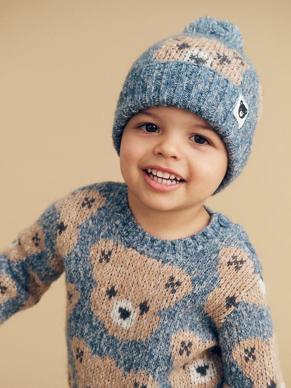 Child wearing the HUXBABY Night Huxbear Knit Beanie and matching knit jumper