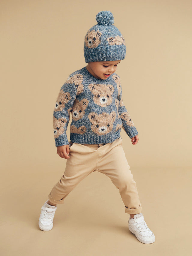 Child wearing the HUXBABY Night Huxbear Knit Beanie, matching knit jumper and chino pants