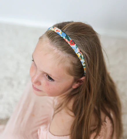 Top view of child wearing JOSIE JOAN'S Lauren Alice headband
