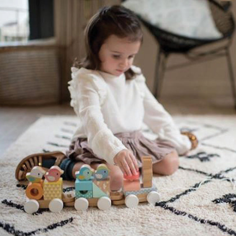 child sitting on floor playing with JANOD Pure Train