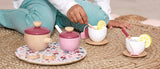 Child sitting on floor playing with JANOD Tea Set