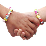 Children wearing Elastic bracelets - Party Bag on left and Rainbow Fruit on right