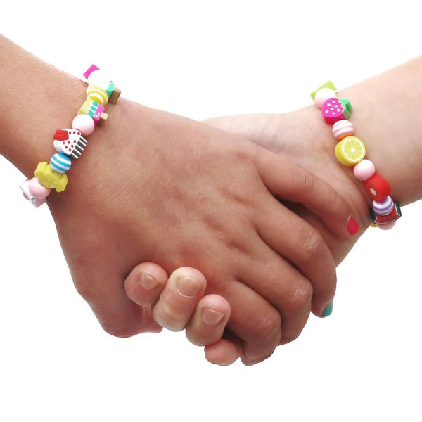 Children wearing Elastic bracelets - Party Bag on left and Rainbow Fruit on right