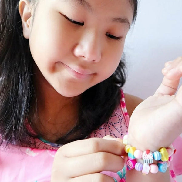 Girl wearing the LAUREN HINKLEY Party Bag Elastic Bracelet