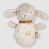 Plush toy sheep with a tag on a light gray background