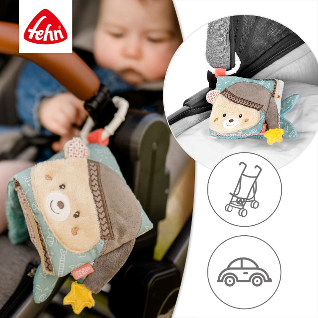 Child in a car seat with a teddy bear toy, featuring the Fehn brand logo.