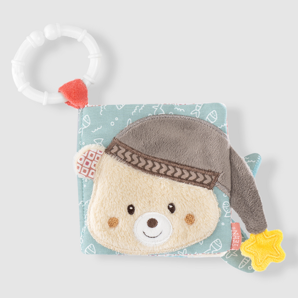 Plush toy BOOK with a bear face and gray hat on a blue background