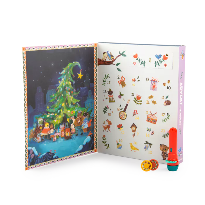 Open Advent Calendar with Christmas-themed illustrations and a torch projector and discs on a white background