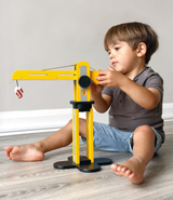 Child playing with the MENTARI Big Yellow Crane