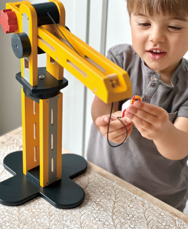 Child playing with MENTARI Big Yellow Crane