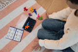 Child on floor playing with IQ Waves games