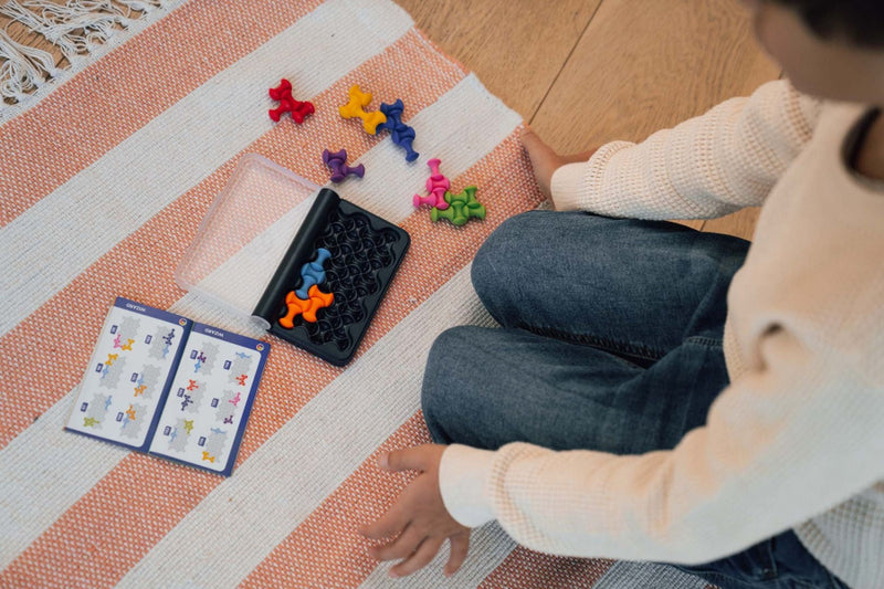 Child on floor playing with IQ Waves games