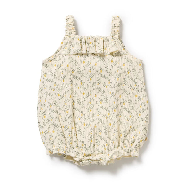Baby romper with lemon leaf pattern and ruffle neckline on a white background