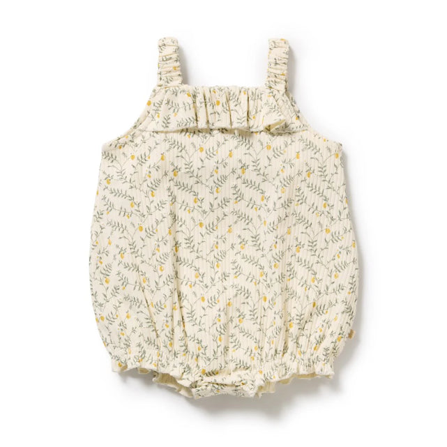 Baby romper with lemon leaf pattern and ruffle neckline on a white background