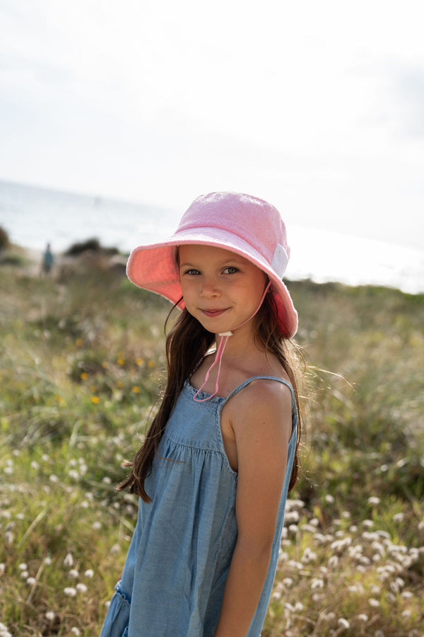 GIRL WEARING ACORN Terry Towelling Bucket Hat - Light Pink AND SINGLET STRAP DENIM DRESS