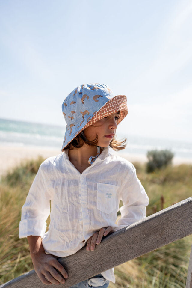 SIDE VIEW OF CHILD WEARING ACORN Platapus Wide Brim Bucket Hat - BRIM TURNED UP