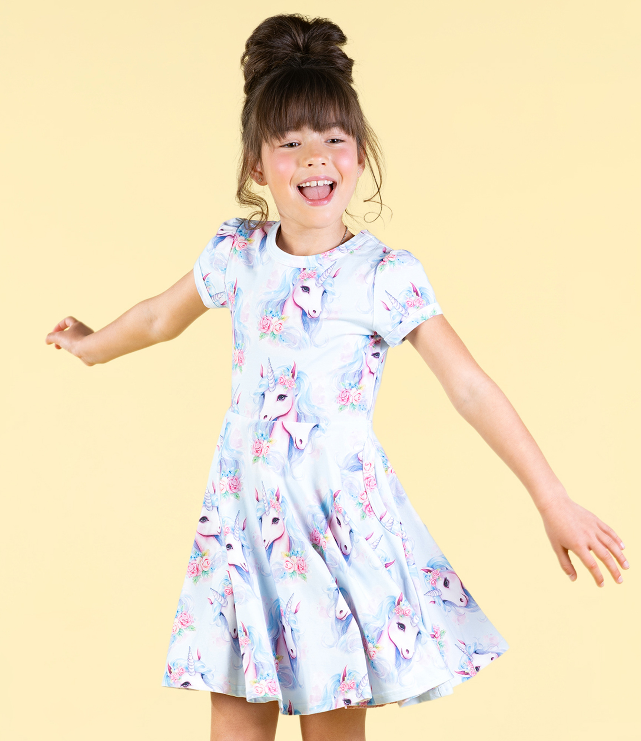 DETAIL VIEW OF GIRL TWIRLING IN THE ROCK YOUR BABY Blue Unicorn Waisted Dress