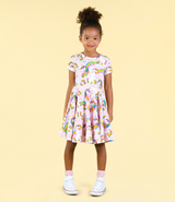 STUDIO SHOT OF GIRL WEARING ROCK YOUR BABY Unicorn Rainbow Waisted Dress