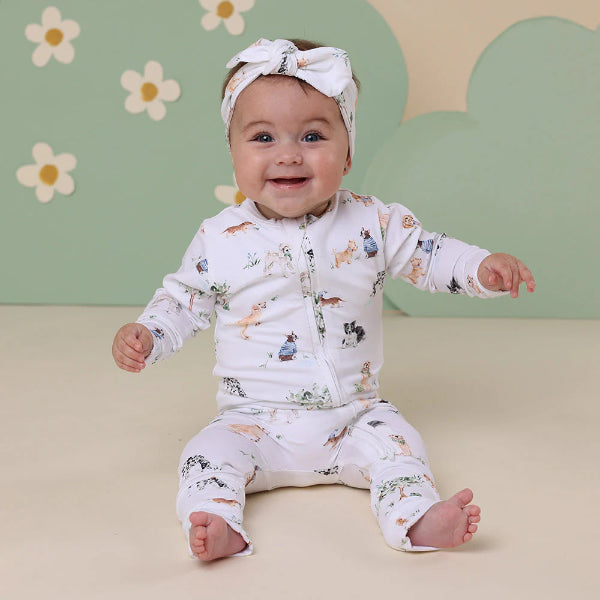 Baby sitting on floor wearing SNUGGLE HUNNY Dog Park Organic Snugglesuit Convertible Romper and matching head band