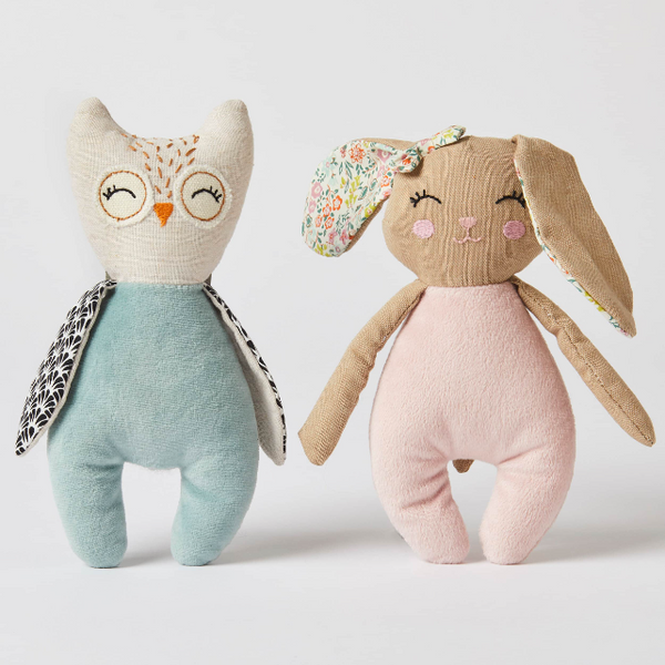 Stuffed owl and rabbit toys on a light background